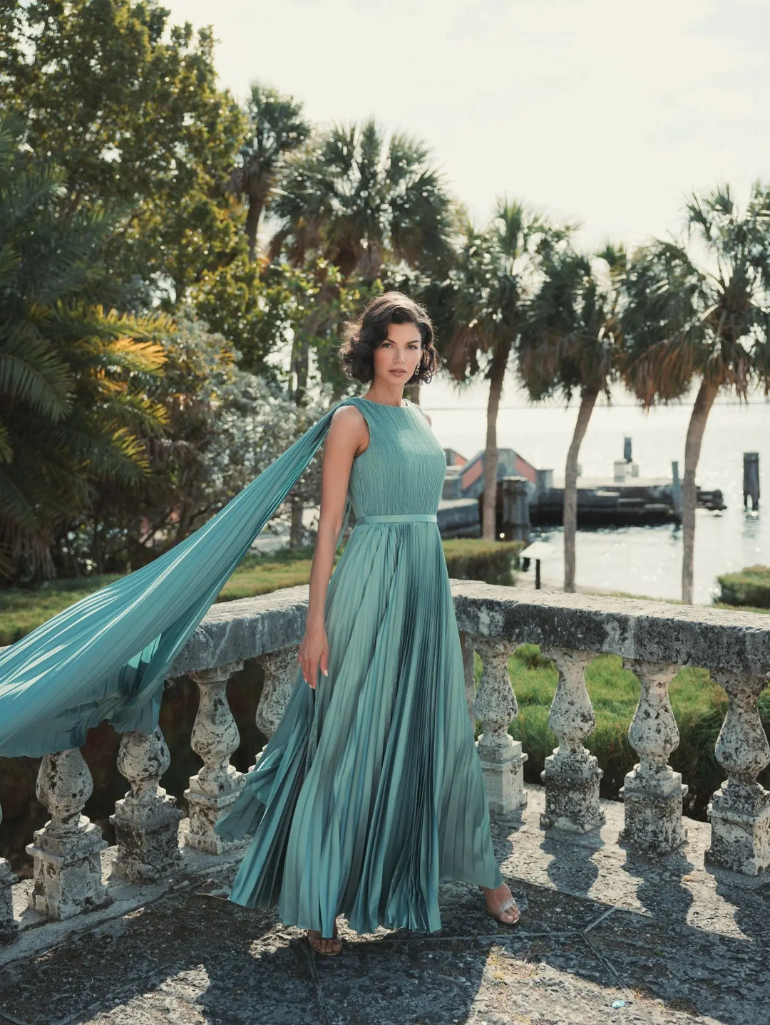 Sleeveless high neck cape back heat pleated gown